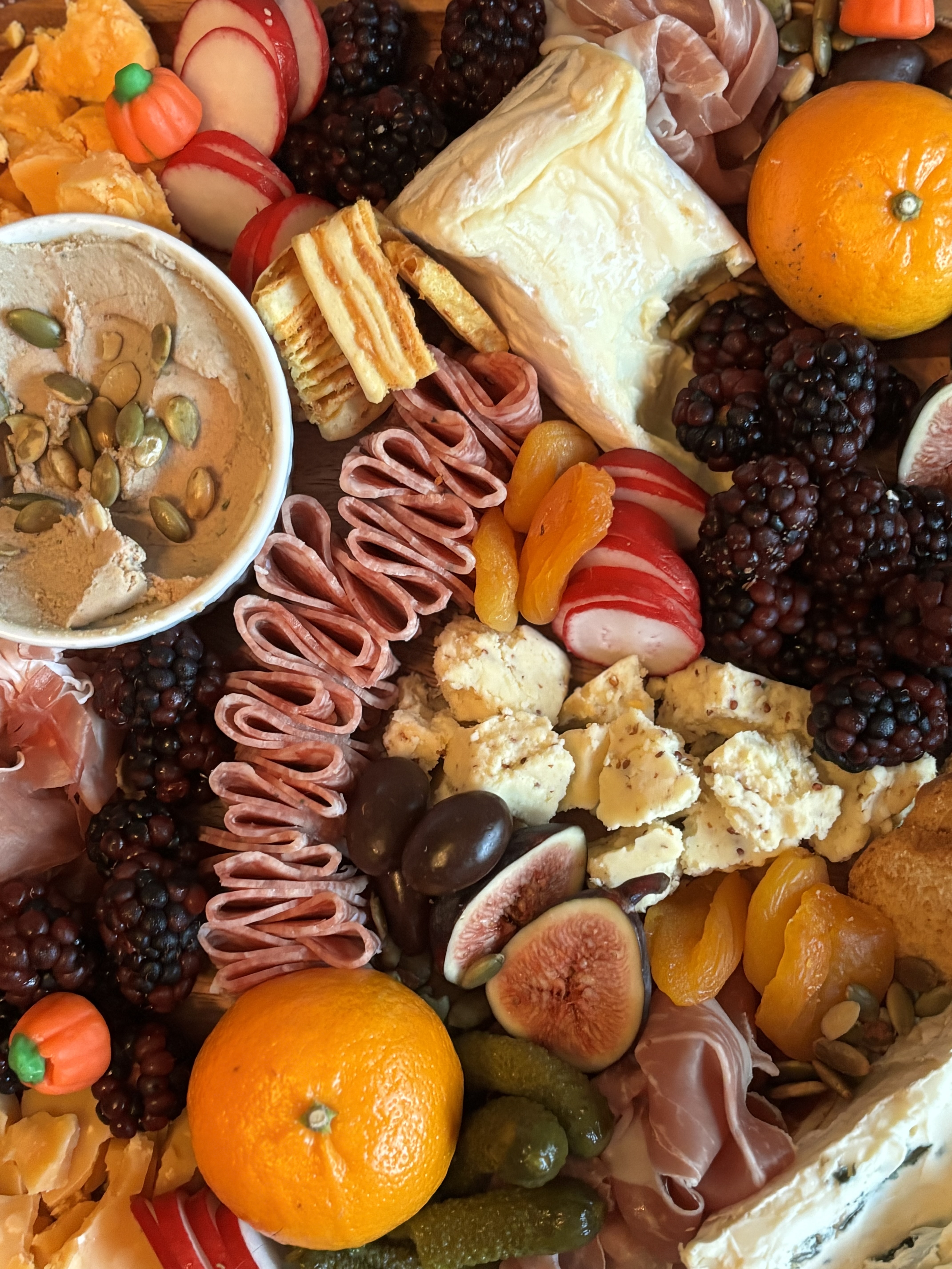 A charcuterie board with Halloween colors.