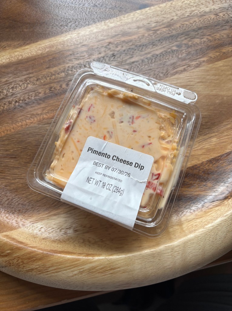 A container of pimento cheese dip.