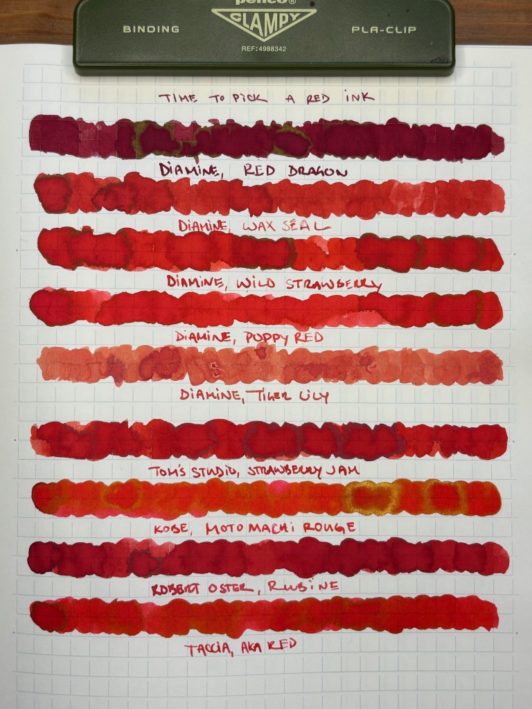 A selection of nine swatched red inks on larger paper.